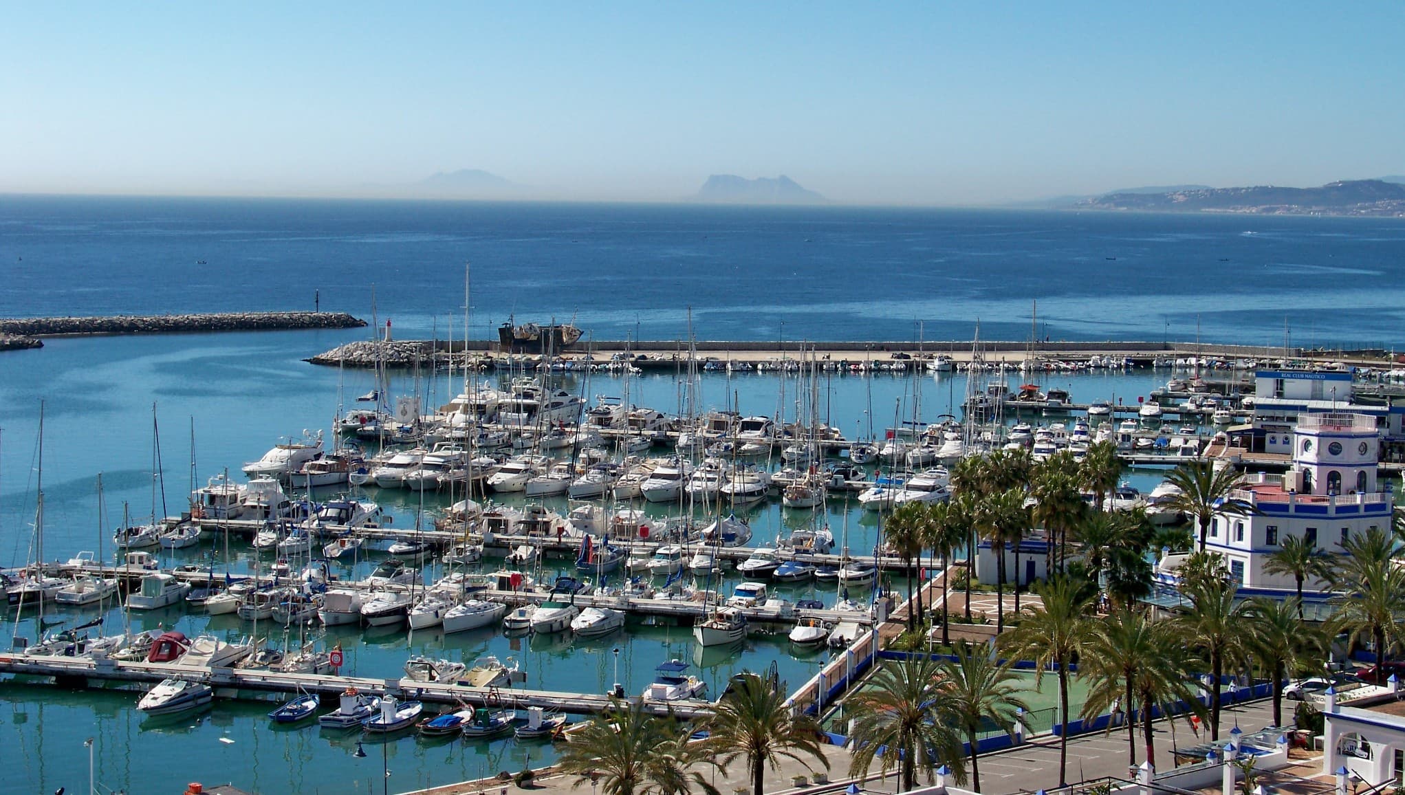 Puerto deportivo de Estepona con sus embarcaciones amarradas y el Peñón de Gibraltar al fondo